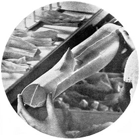 Fig. 52 Examining hose for defects prior to the dyeing and finishing process.